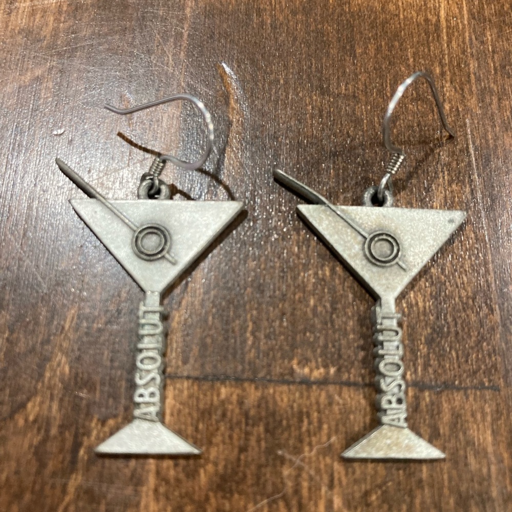 “Absolute Vodka” martini, and olive earrings.